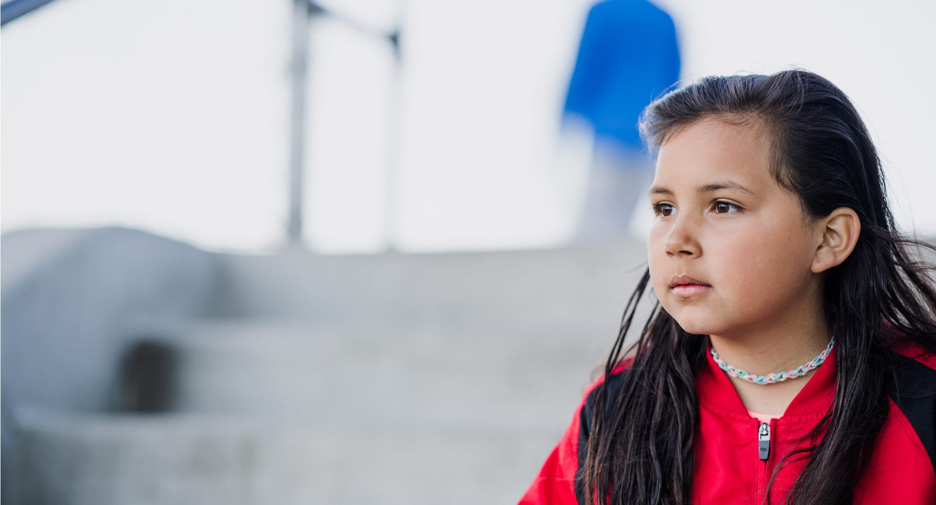 girl in red walking down stairs
