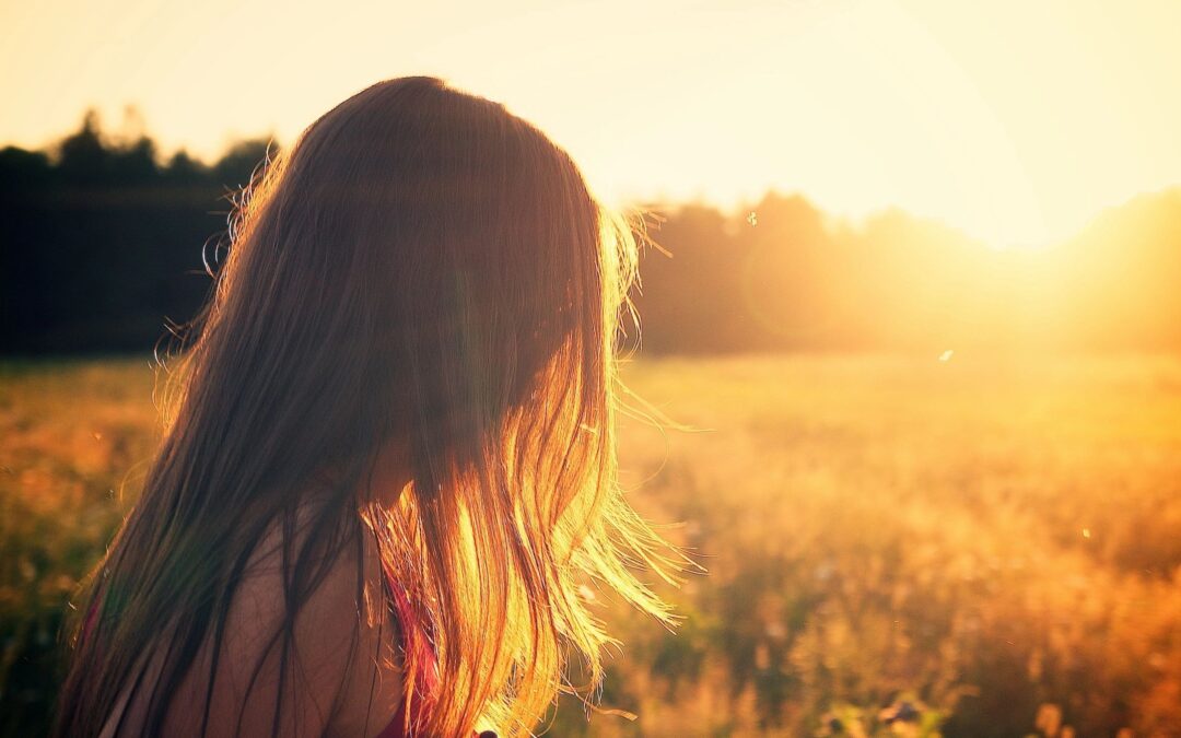 young girl staring into the sunset